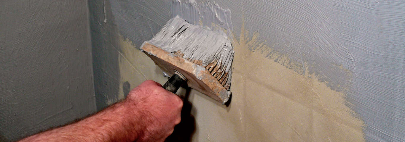 malarz maluje płytki w łazience farbą do malowania płytek