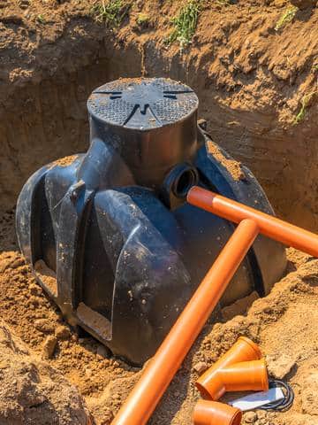 Montaż plastikowego szamba z podłączeniem rur kanalizacyjnych w wykopie