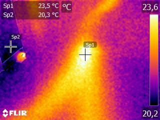 Obraz termowizyjny przedstawiający rozkład temperatur, z zaznaczonymi punktami pomiarowymi Sp1 i Sp2, wskazującymi odpowiednio 23.5°C i 20.3°C, skala temperatur po prawej stronie obrazu.
