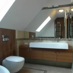 Nowoczesna łazienka na poddaszu ze skośnym sufitem, drewnianymi elementami i dużą umywalką. Lustro z oświetleniem i mozaiką. Widoczny fragment wanny.