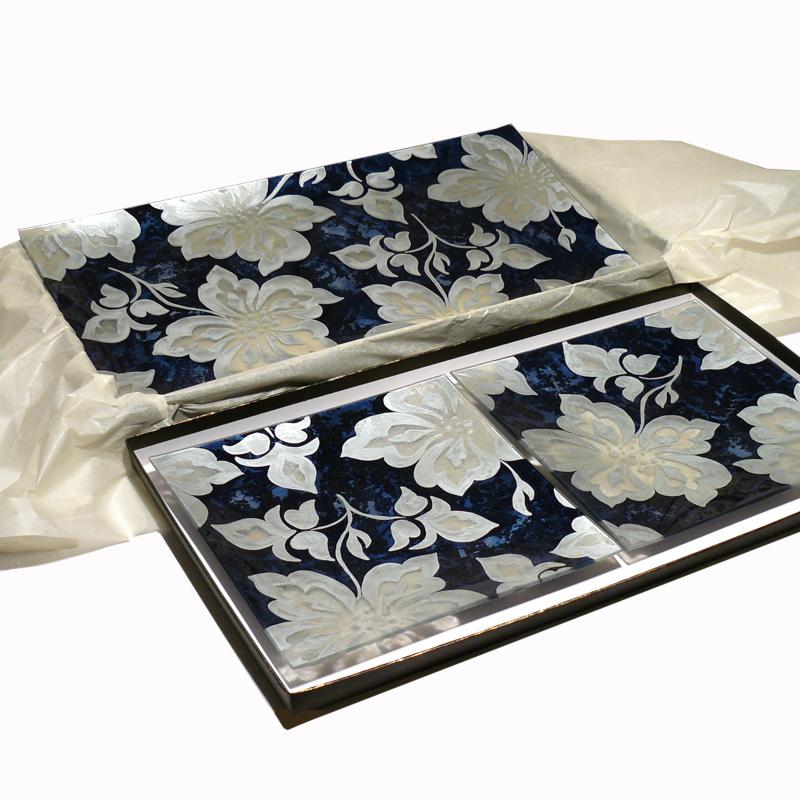 Dekoracyjny talerz prostokątny z motywem białych kwiatów na granatowym tle, zapakowany w pudełko z bibułą.