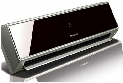 Elegancki klimatyzator Samsung z czarnym panelem i srebrną obudową, wyświetlający temperaturę 21 stopni, sfotografowany z niskiego kąta z widocznym odbiciem na błyszczącej powierzchni.