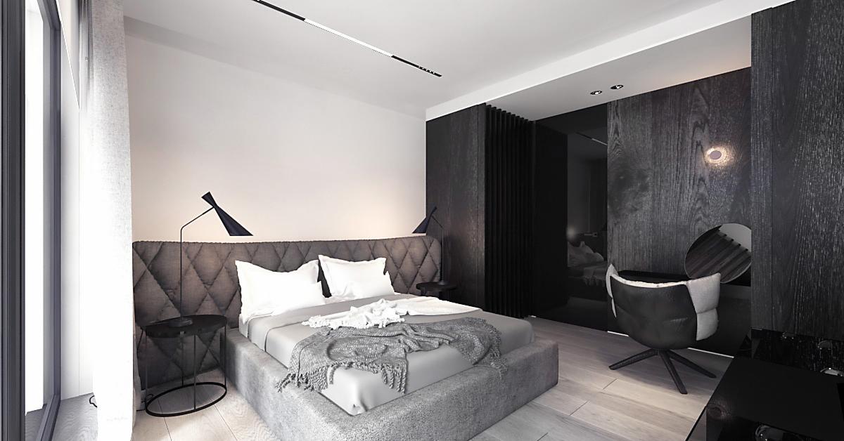 Nowoczesna sypialnia w odcieniach szarości i czerni z pikowanym zagłówkiem, minimalistycznymi lampami i drewnianą ścianą z ukrytym oświetleniem.