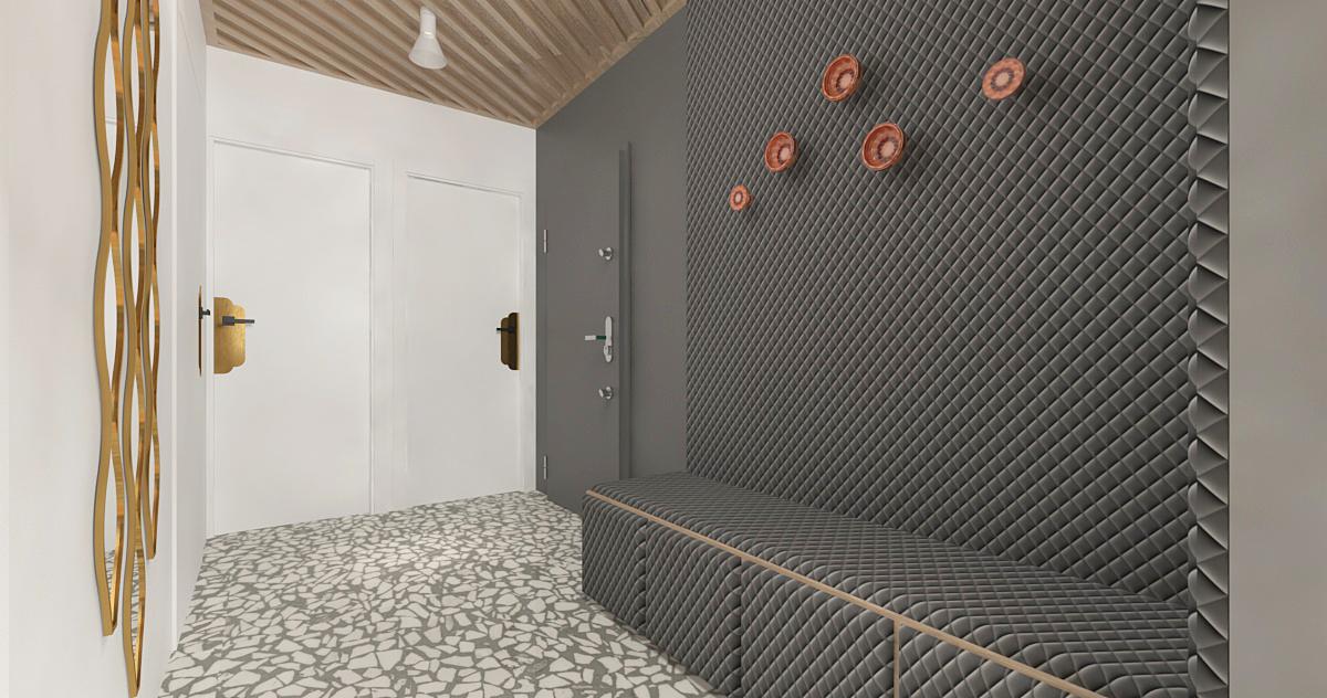 Nowoczesny przedpokój z szarą tapicerowaną ścianą, wbudowaną ławką z drewnianym obramowaniem, dekoracyjnymi ceramicznymi elementami na ścianie, białymi drzwiami i podłogą w stylu lastryko.