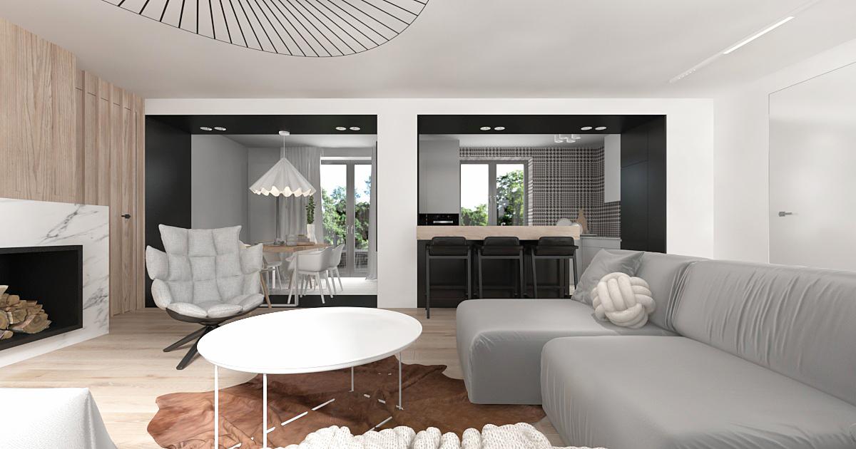 Nowoczesny salon z otwartą kuchnią i jadalnią, szara sofa z dekoracyjną poduszką węzłem, biały stolik kawowy na brązowym dywanie, fotel obrotowy przy marmurowym kominku, widok na jadalnię i kuchnię...