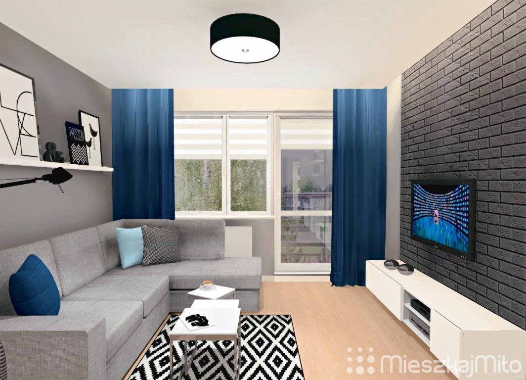 Wizualizacja salonu w Katowicach: szara sofa narożna z niebieskimi poduszkami, czarno-biały dywan geometryczny, stoliki kawowe, ściana z cegły, telewizor, niebieskie zasłony i okno z roletami.