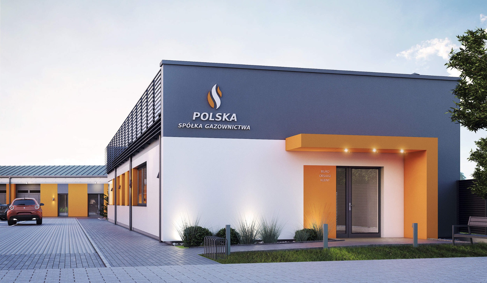 Nowoczesny budynek biurowy w kolorach szarości, bieli i pomarańczu z logo 'Polska Spółka Gazownictwa' na elewacji, oświetlony punktowymi lampami, z widocznym fragmentem parkingu i zieleni.