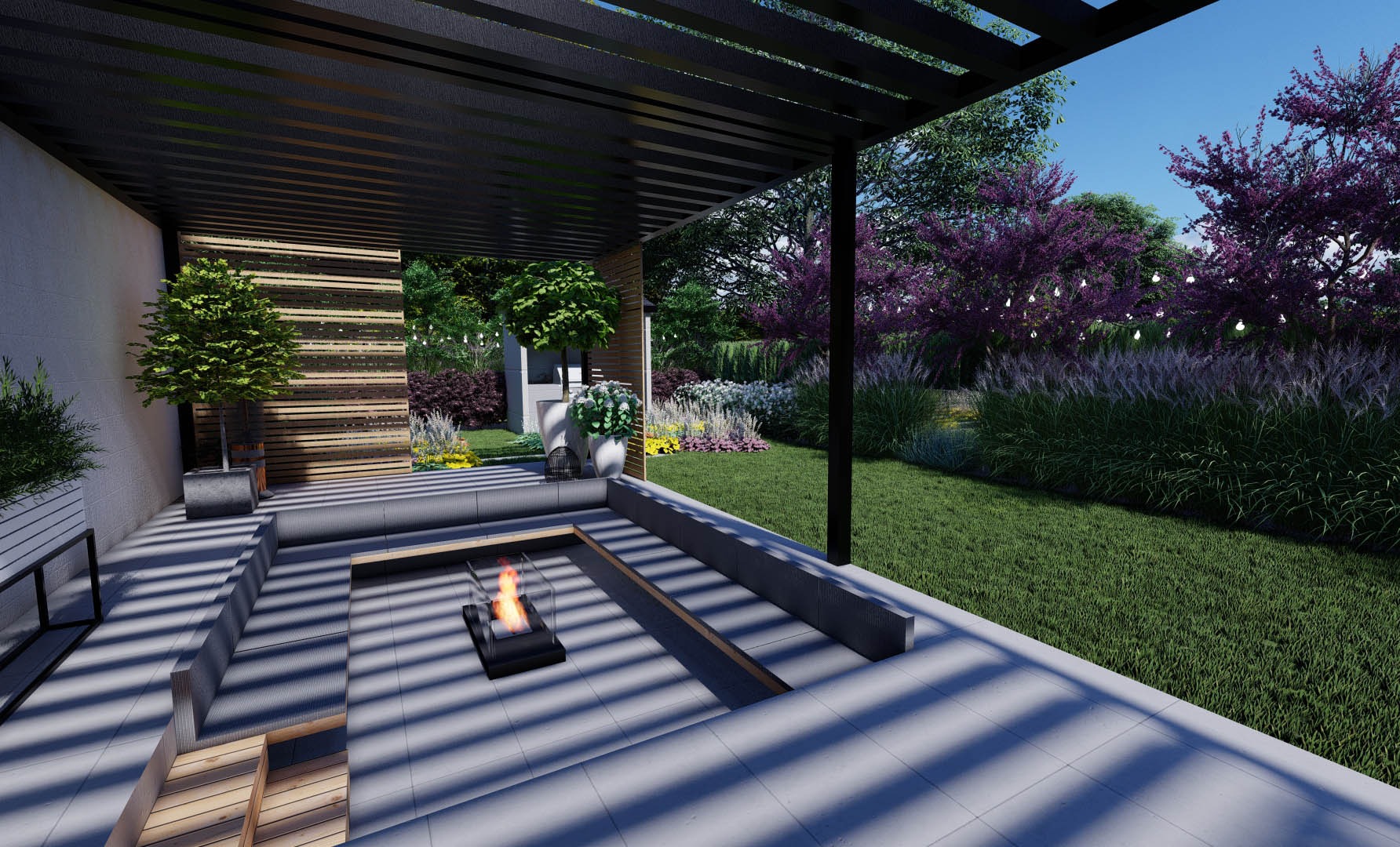Wizualizacja nowoczesnego tarasu z paleniskiem na zewnątrz, otoczonego zielenią i drzewami kwitnącymi na fioletowo, z oświetleniem dekoracyjnym.