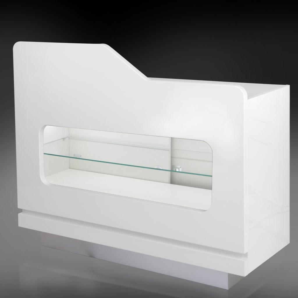 Biała, lakierowana lada sklepowa z przeszkloną witryną i półkami, na szarym tle.