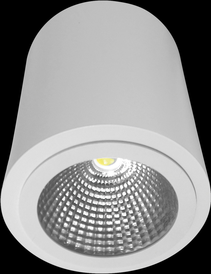 Biała, natynkowa oprawa LED z rastrem odbijającym światło, widoczna od dołu na czarnym tle.
