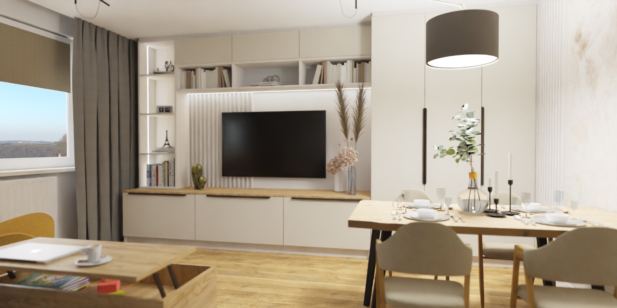 Jasne wnętrze salonu z jadalnią, minimalistyczny design, drewniany stół z nakryciem, telewizor na ścianie z dekoracyjną zabudową, stolik kawowy z laptopem i filiżanką.