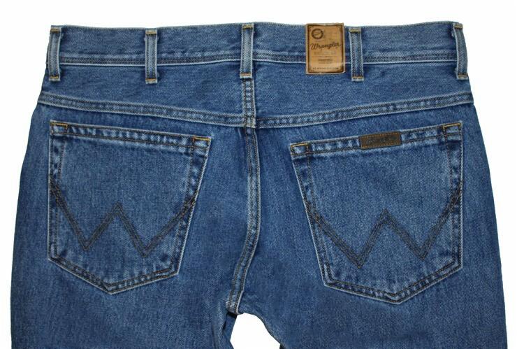 Niebieskie jeansy marki Wrangler, widok z tyłu, z charakterystycznym wzorem na kieszeniach i skórzaną naszywką z logo na pasku.