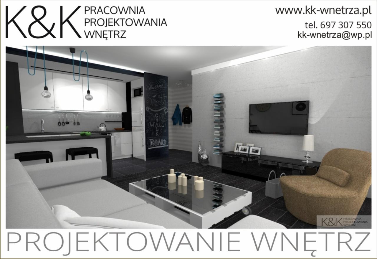 Wizualizacja nowoczesnego wnętrza mieszkania z aneksem kuchennym, szarą sofą, szklanym stolikiem kawowym na kółkach, czarną ścianą z napisem kredą, telewizorem i brązowym fotelem.