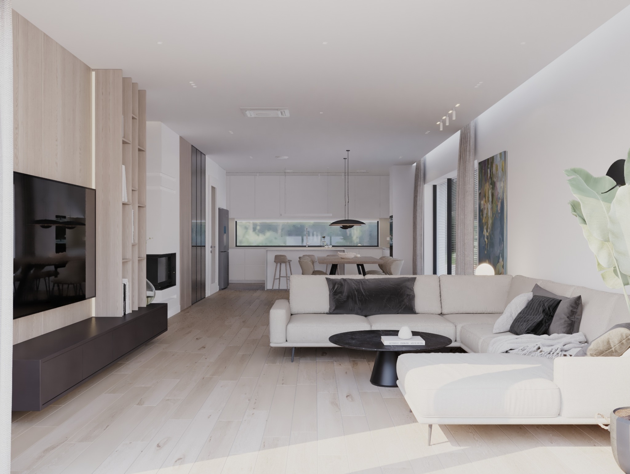 Jasny salon z drewnianą podłogą, narożną sofą z szarymi poduszkami, czarnym stolikiem kawowym i telewizorem na tle drewnianej zabudowy z półkami, z widokiem na białą kuchnię w tle.