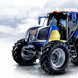 Nowoczesny, niebiesko-żółty traktor na tle pochmurnego nieba, Wałbrzych