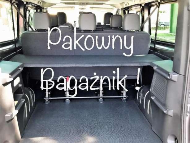 Wnętrze busa z widocznym, przestronnym bagażnikiem i rozkładanymi siedzeniami, z napisem 'Pakowny Bagażnik!' na zdjęciu.
