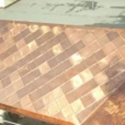 Miedziany dach ułożony w romby, widok z góry, delikatne refleksy światła na metalicznej powierzchni.