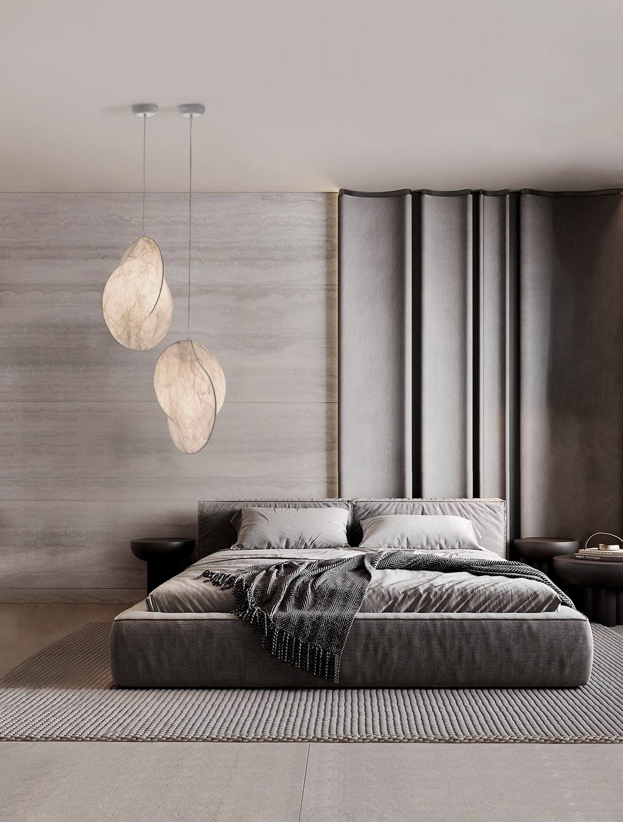 Nowoczesna sypialnia w odcieniach szarości z designerskimi lampami wiszącymi o organicznym kształcie, zwisającymi nad łóżkiem. Minimalistyczny wystrój.