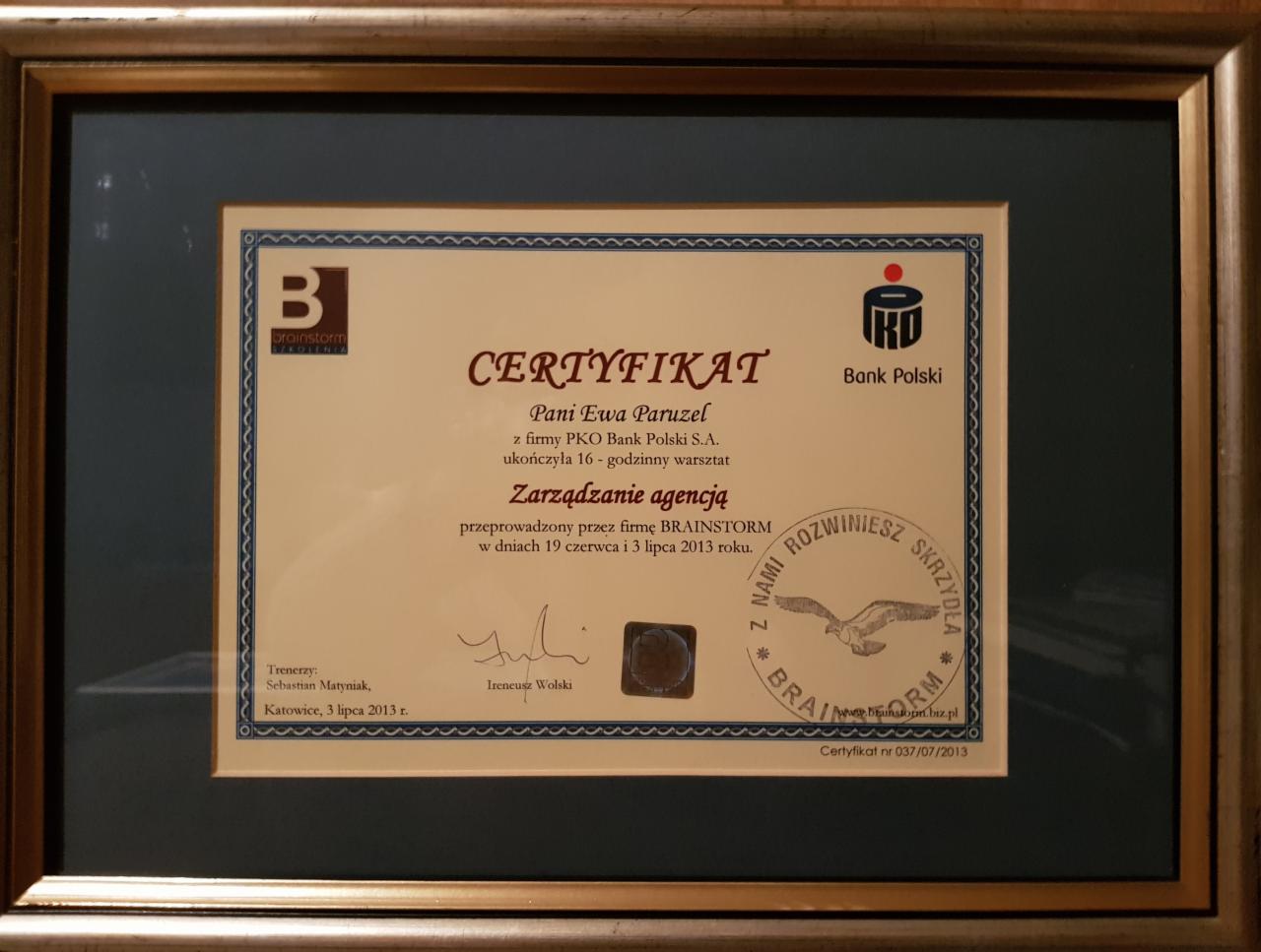 Oprawiony w ramkę certyfikat ukończenia warsztatu 'Zarządzanie agencją' przez Panią Ewę Paruzel z PKO Bank Polski S.A., przeprowadzony przez firmę Brainstorm w dniach 19 czerwca i 3 lipca 2013 roku...