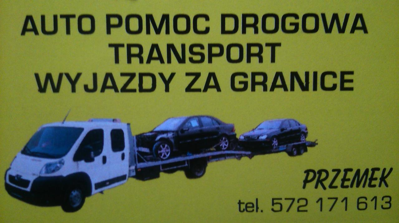 Żółta reklama: laweta transportuje dwa czarne samochody. Napis: Auto Pomoc Drogowa, Transport, Wyjazdy za Granicę, Przemek, tel. 572 171 613.