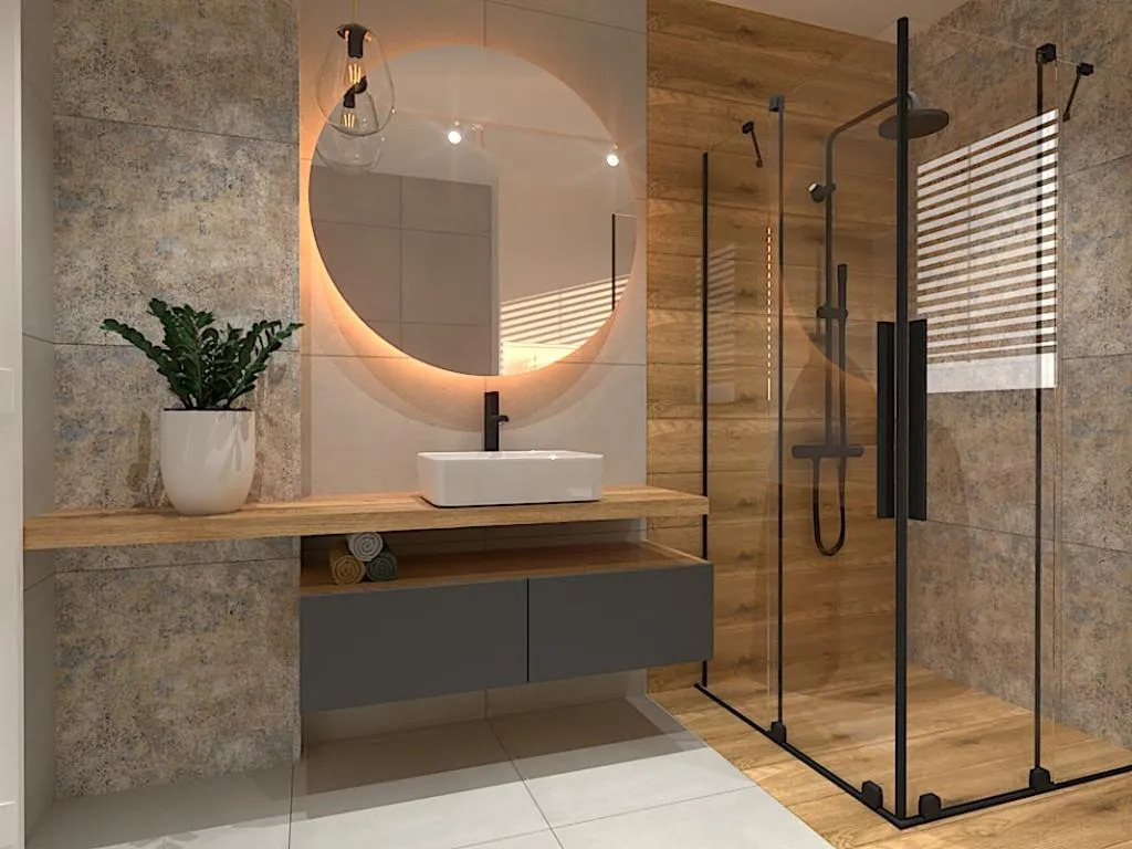 Nowoczesna łazienka z kabiną prysznicową typu walk-in, okrągłym lustrem z podświetleniem LED i drewnianymi akcentami. Minimalistyczna umywalka nablatowa.