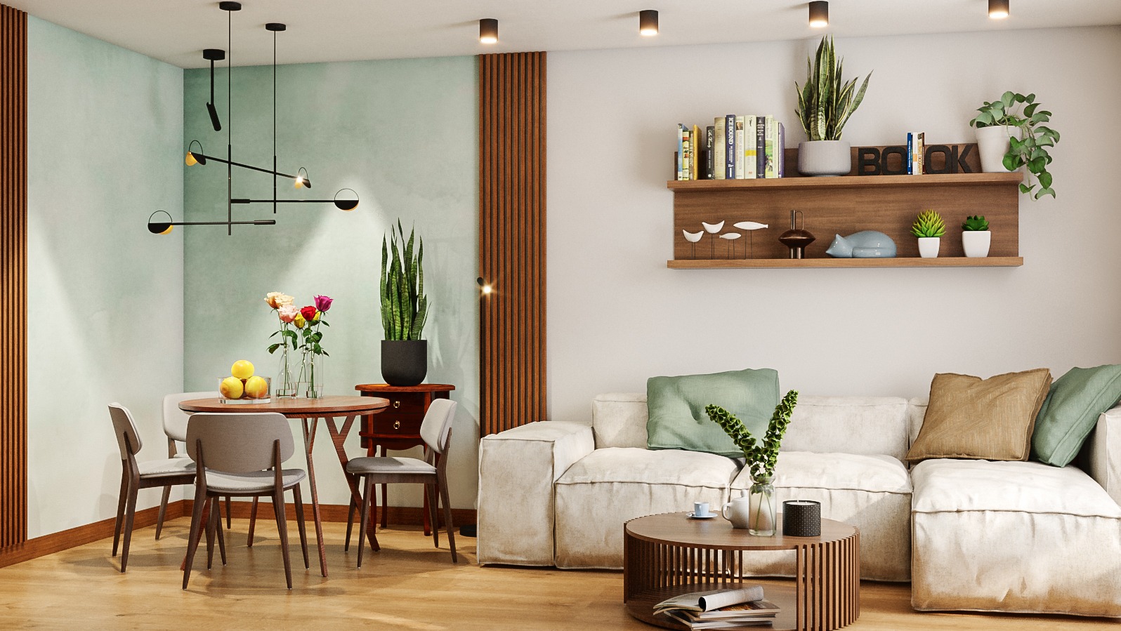 Salon z jadalnią w Luboniu: okrągły stół z owocami i kwiatami, nowoczesna lampa wisząca, sofa modułowa z poduszkami w odcieniach zieleni i beżu, drewniana półka z dekoracjami.