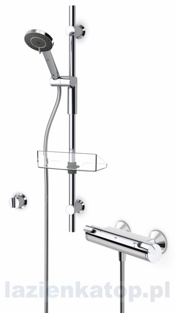 Bateria prysznicowa Oras Optima z zestawem natryskowym, chromowana, z półką na kosmetyki, zamontowana na białej ścianie.