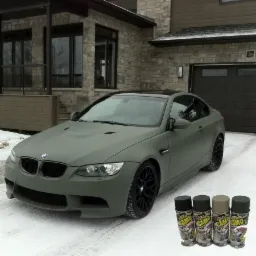 Matowy, oliwkowy BMW E92 po zmianie koloru z użyciem farby Plastidip Camo, stojący na śniegu przed domem.