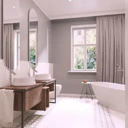 Jasna łazienka z dwoma owalnymi lustrami, drewnianą szafką pod umywalki, białą wanną wolnostojącą i wzorzystymi płytkami podłogowymi.