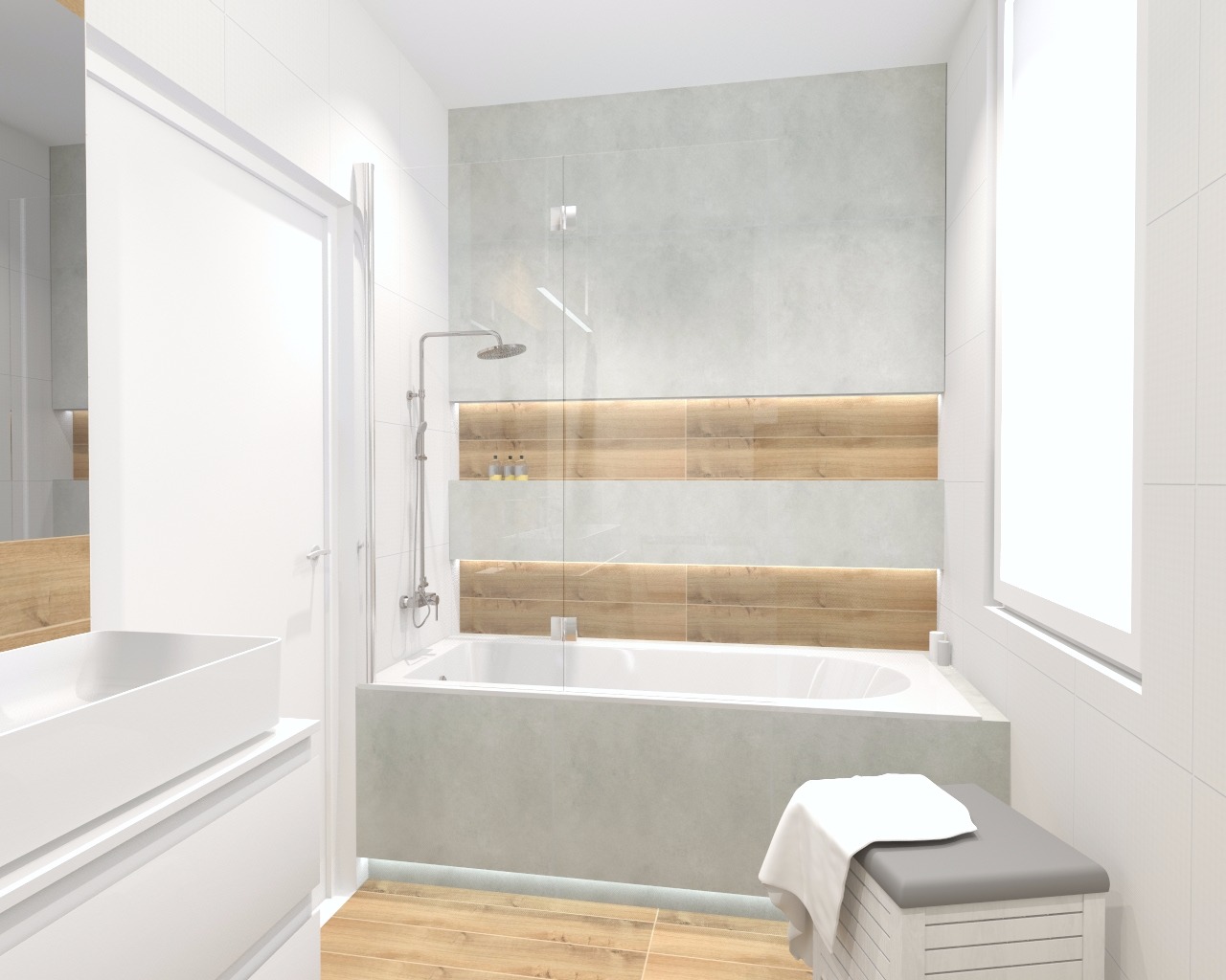 Jasna łazienka z wanną obudowaną szarą płytką, prysznicem, drewnianymi akcentami na ścianie i białymi meblami łazienkowymi, oświetlona światłem dziennym z okna.
