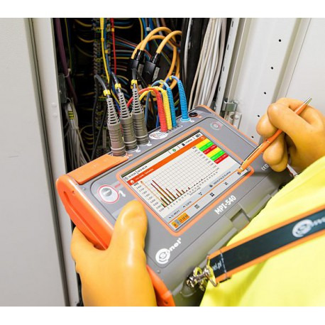 Pomiar parametrów instalacji elektrycznej za pomocą miernika MPI-540, widoczne przewody i rozdzielnica w tle.