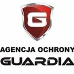 Logo Agencji Ochrony 'Guardia' z czerwonym, błyszczącym symbolem tarczy z literą 'G' w górnej części, poniżej napis 'Agencja Ochrony' i nazwa 'Guardia' w pogrubionej czcionce.