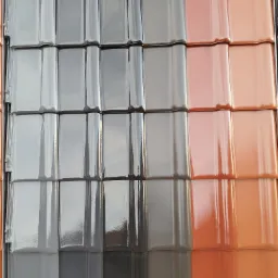 Różnokolorowe dachówki ceramiczne marki Piemont, prezentowane obok siebie w ekspozytorze, odcienie szarości i brązu.