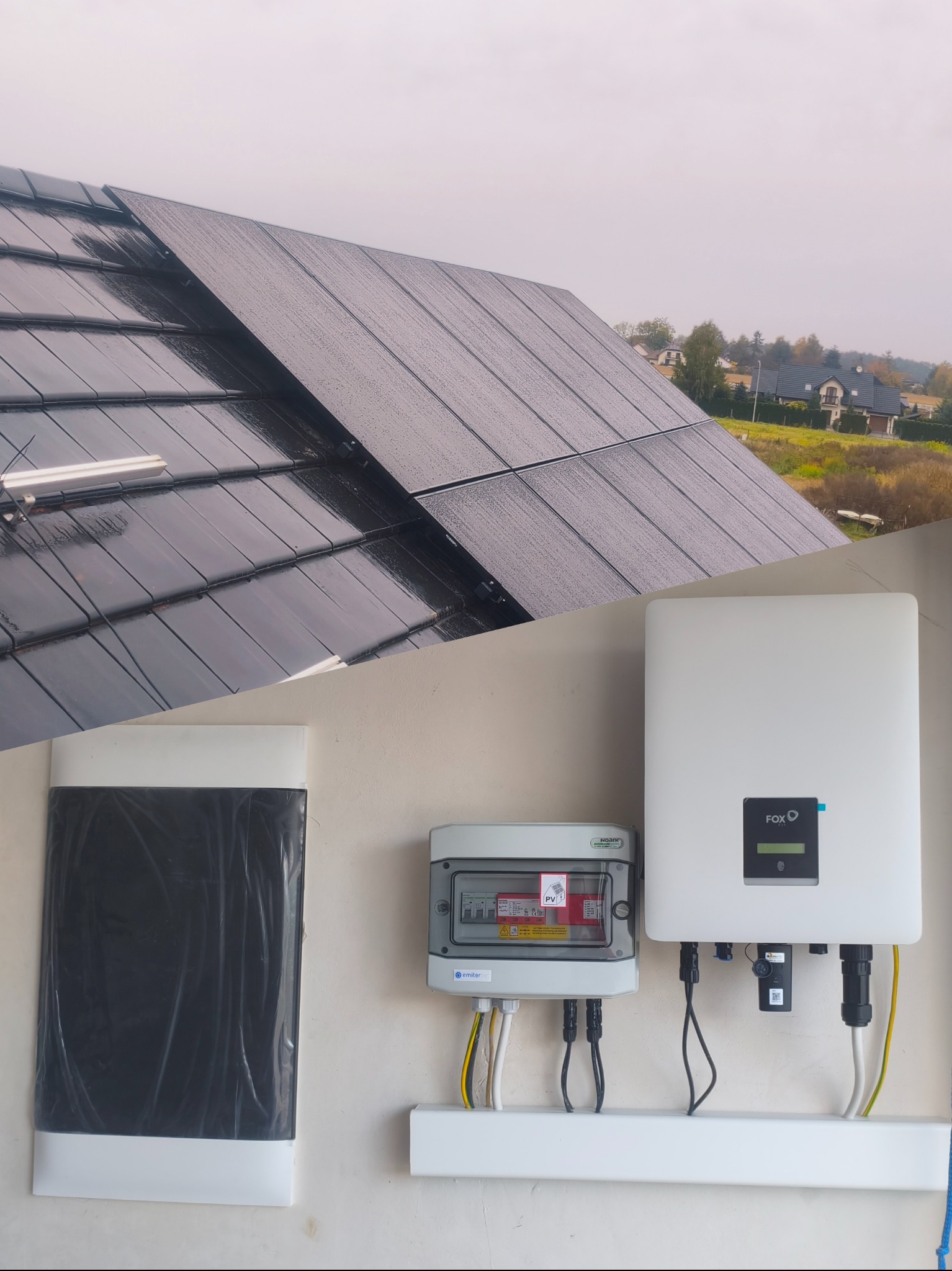 Panel słoneczny na dachu z widocznym inwerterem i skrzynką elektryczną. Instalacja fotowoltaiczna w deszczowy dzień. Widok na domy w tle.