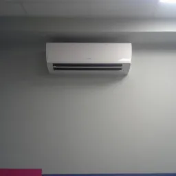 Biały klimatyzator Fujitsu zamontowany na szarej ścianie w biurze, widoczny fragment sufitu i listwy przypodłogowej.