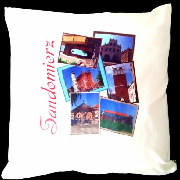 Biała poduszka z nadrukiem zdjęć zabytków Sandomierza i napisem „Sandomierz” w kolorze czerwonym, ułożonych w kolaż na czarnym tle.
