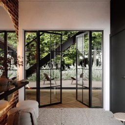 INTUS GROUP - Nowoczesna łazienka z wyjściem na taras, ceglana ściana z lustrem, pufa z narzutą i szpilki na podłodze z lastryko.