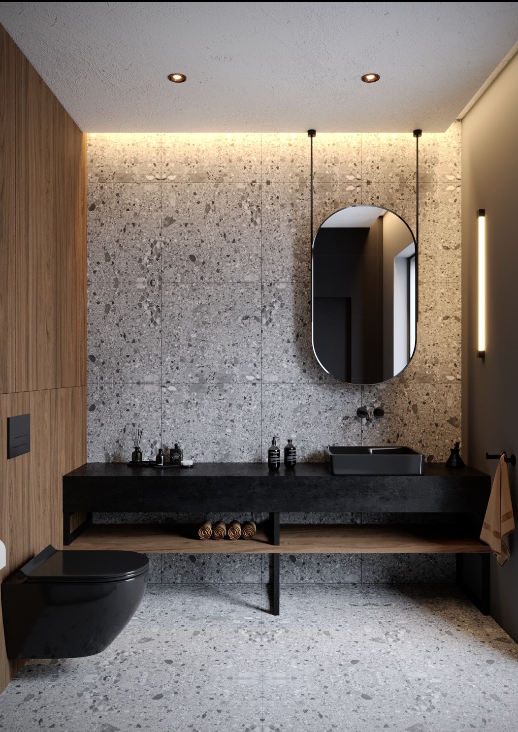 Nowoczesna łazienka z czarną armaturą, umywalką i wiszącą toaletą na tle ściany z szarej mozaiki i drewnianych paneli, oświetlona listwą LED.