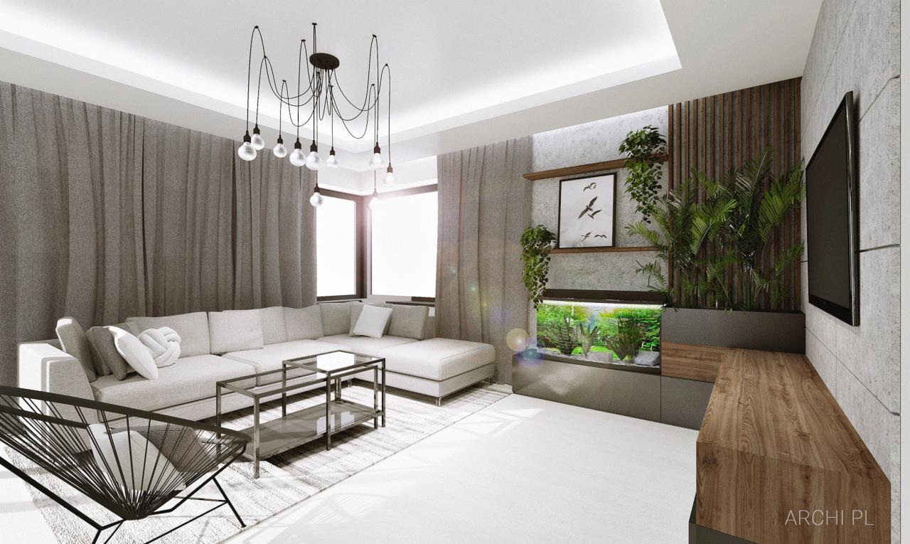 Nowoczesny salon z narożną sofą, szarymi zasłonami, akwarium w zabudowie, wiszącą lampą z żarówkami oraz minimalistycznym stolikiem kawowym i fotelem.