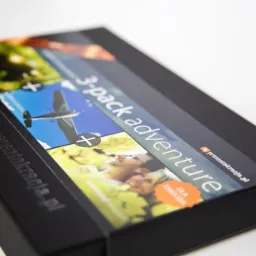 Eleganckie, czarne pudełko prezentowe z motywem '3-pack adventure' i logo prezentokracja.pl, ukazujące różnorodne atrakcje.