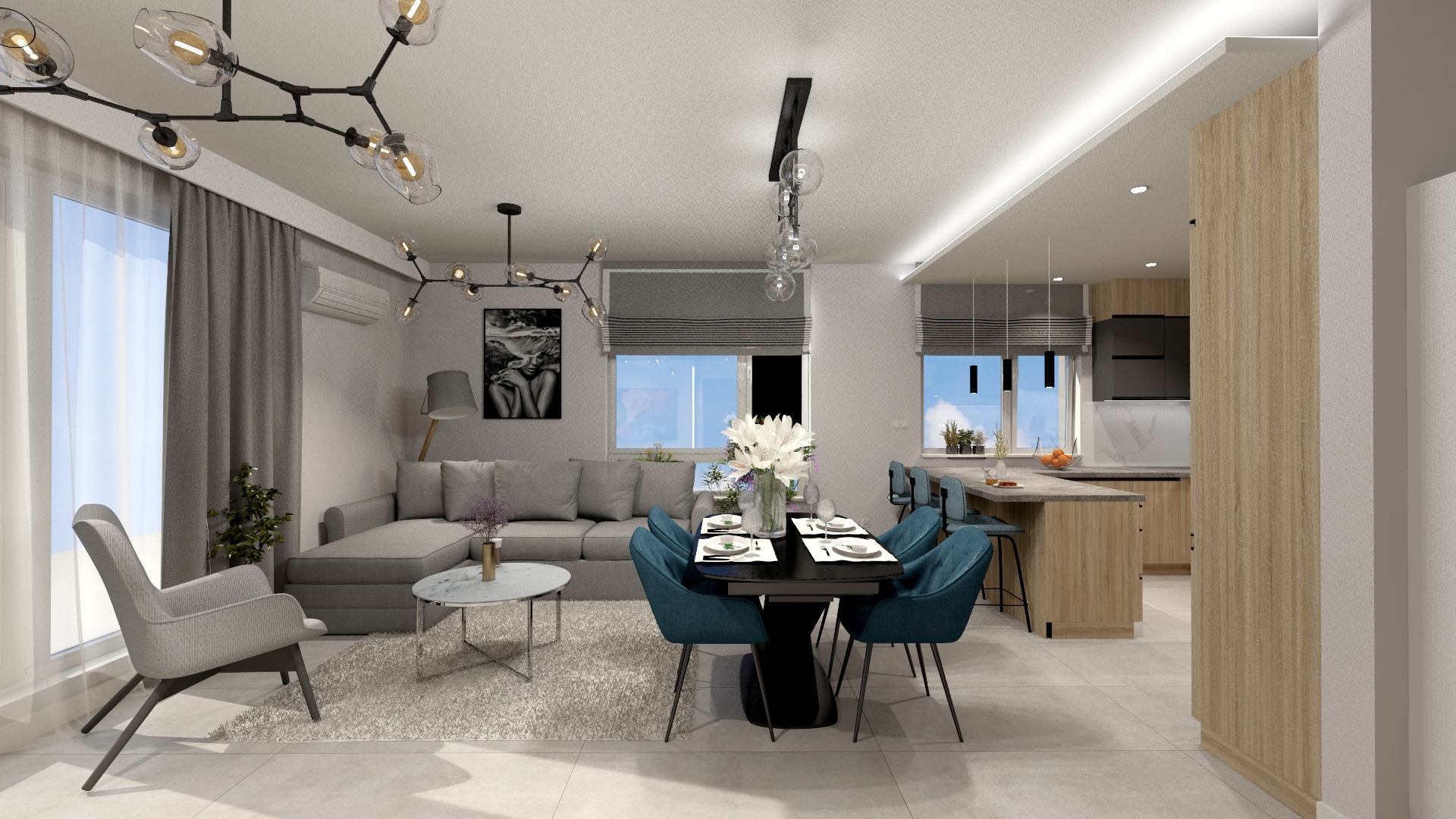 Wnętrze salonu z aneksem kuchennym w odcieniach szarości i błękitu, z nowoczesnym oświetleniem, szarym narożnikiem i ciemnym stołem jadalnym z turkusowymi krzesłami.