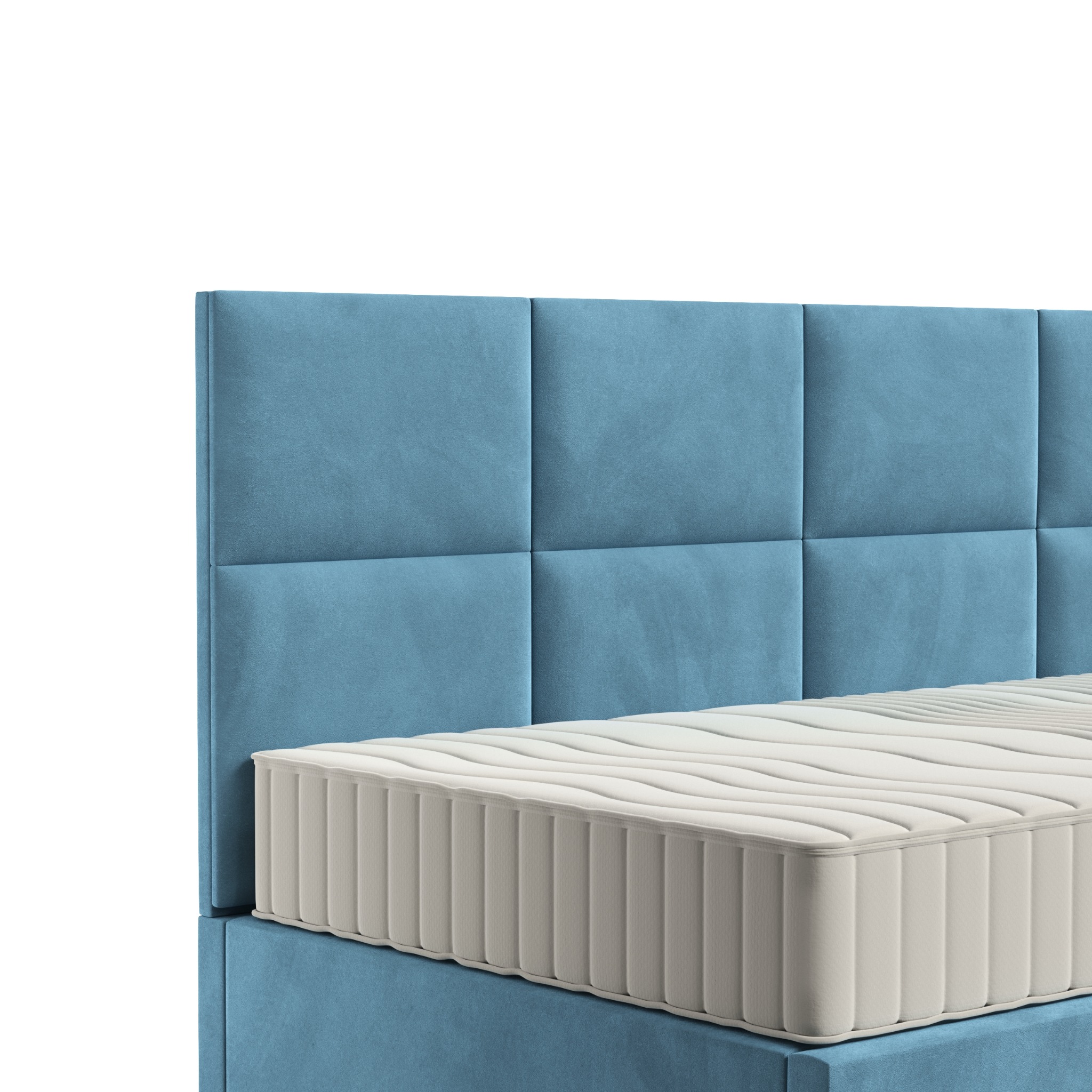 Fragment łóżka z wezgłowiem obitym błękitną tkaniną w kwadraty i materacem z widocznymi przeszyciami.