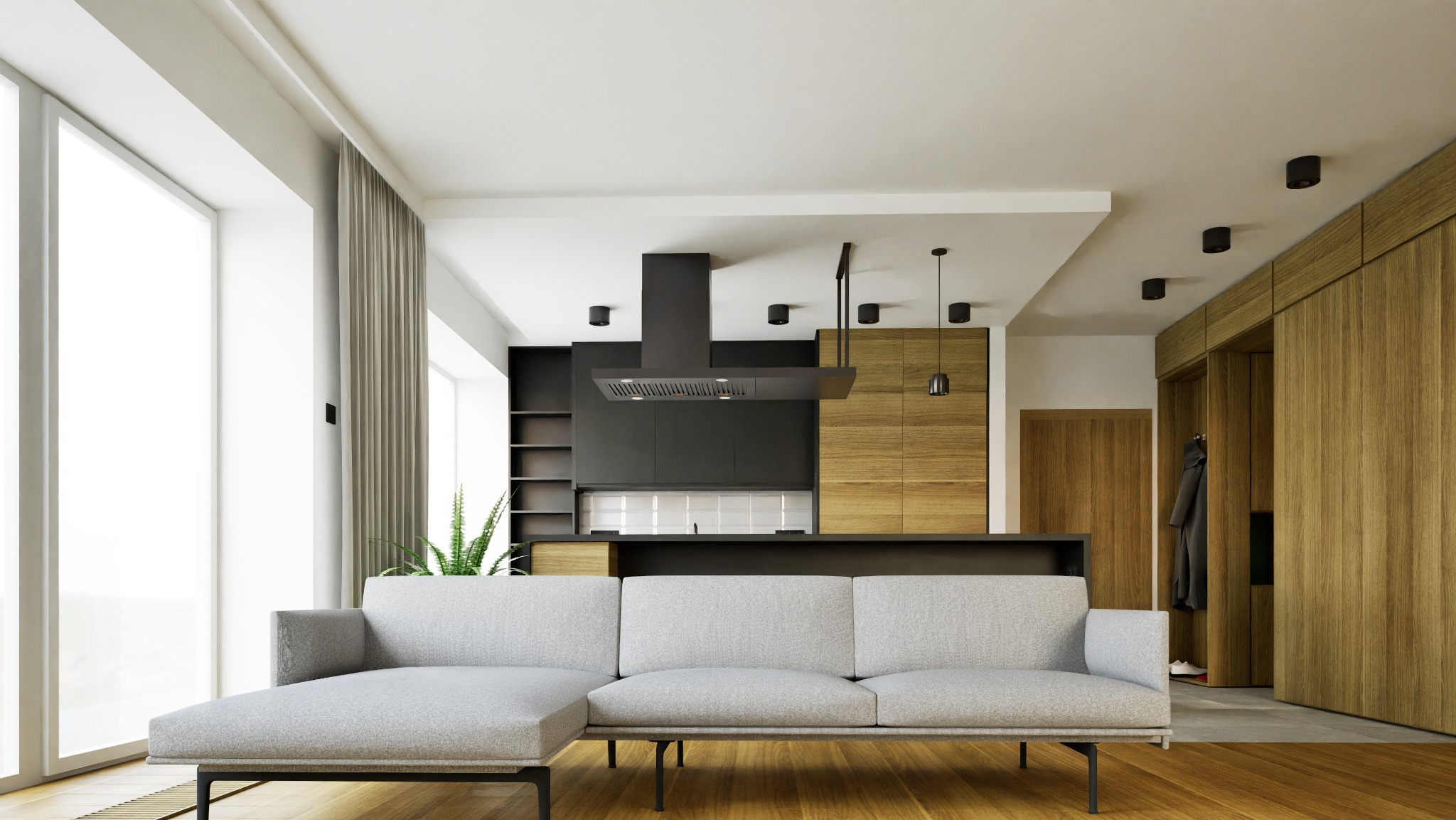 Nowoczesne wnętrze: szara sofa narożna na tle otwartej kuchni z drewnianymi frontami i czarnym okapem. Duże okno z zasłonami dopełnia całość.