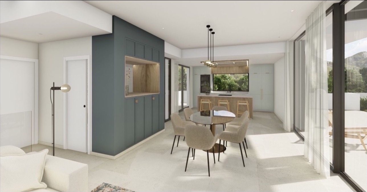 Jasne wnętrze z aneksem kuchennym i jadalnią. Duże okna z widokiem na zieleń. Minimalistyczny design, stonowana kolorystyka, okrągły stół i zabudowa ścienna.