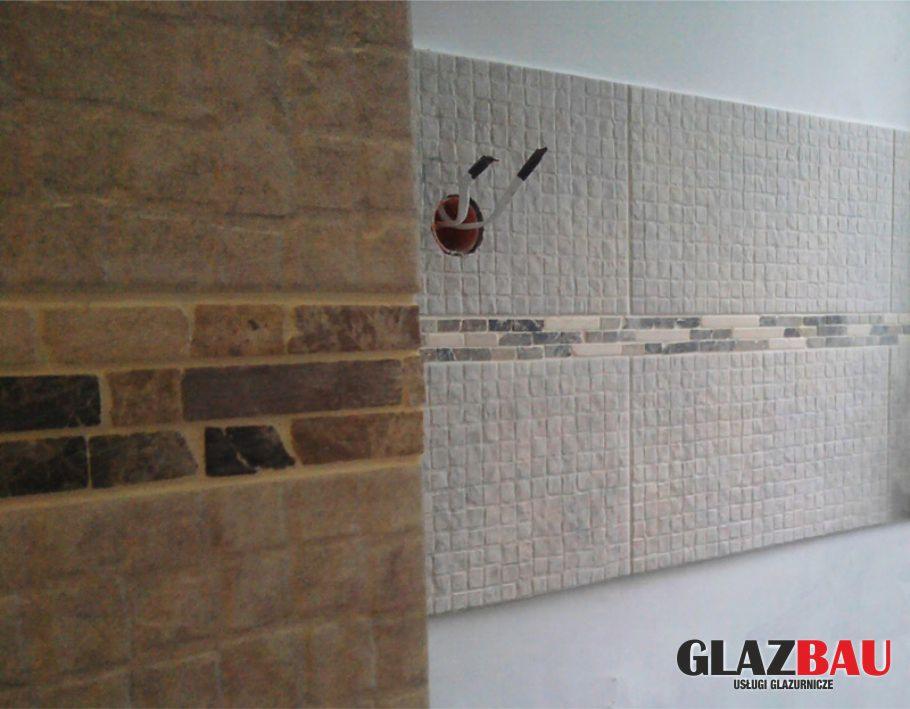 Fragment ściany z beżowymi płytkami imitującymi cegłę i mozaiką, oraz białymi płytkami z szarą mozaiką. Widoczne przewody elektryczne.