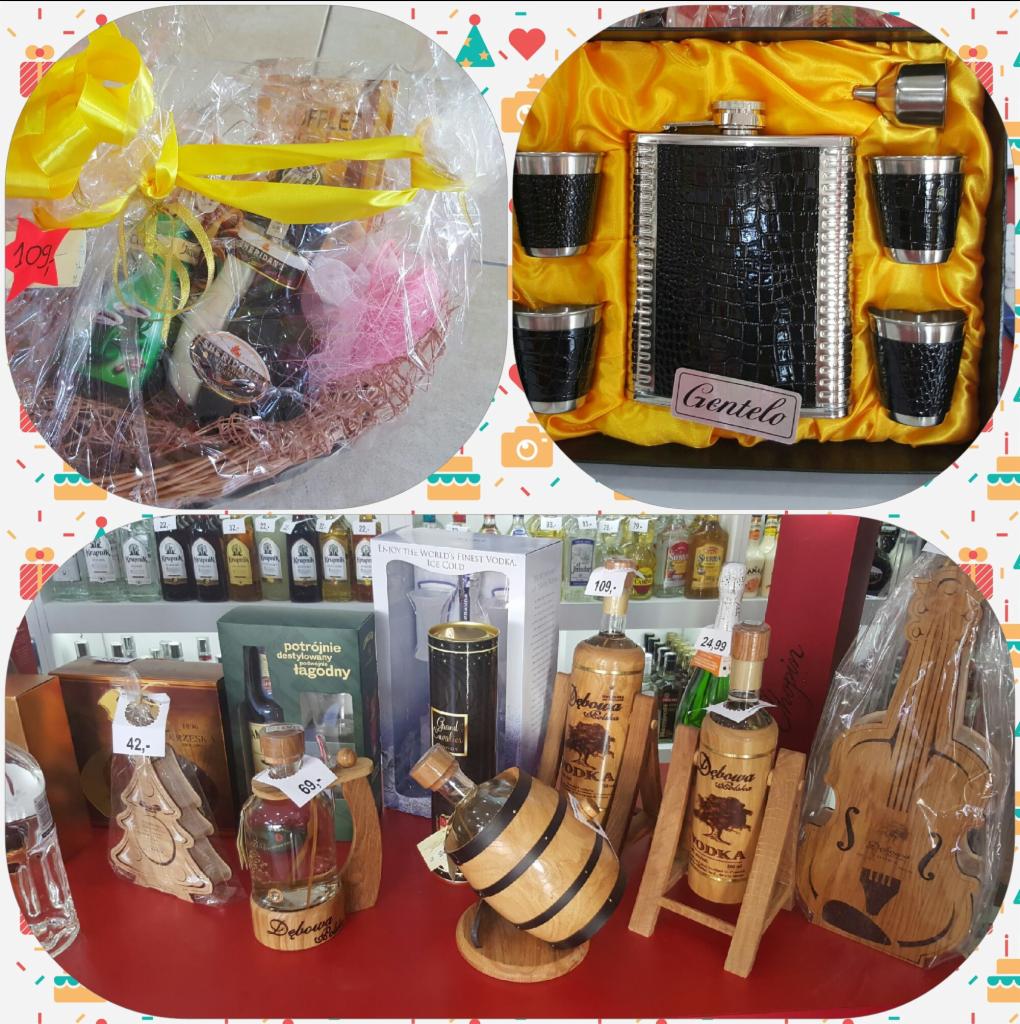 Zestaw upominkowy z alkoholem w koszyku z żółtą wstążką, piersiówka z kieliszkami w ozdobnym pudełku oraz różnorodne butelki alkoholi na półce sklepowej, w tym Dębowa w drewnianych stojakach...