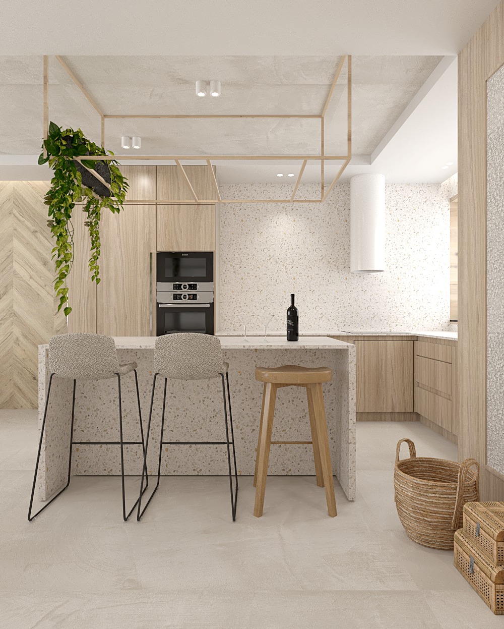 Jasna kuchnia z wyspą i trzema stołkami: dwa z tapicerowanymi siedziskami na metalowych nogach, jeden drewniany. Na blacie butelka wina i kieliszki. Wisząca roślina w lewym górnym rogu.