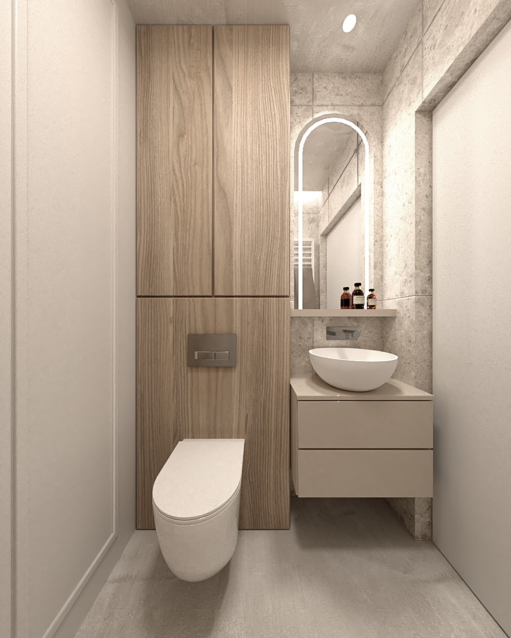 Minimalistyczna łazienka z podwieszaną toaletą, umywalką nablatową i szafką z drewnianymi frontami, oświetlonym lustrem w kształcie łuku i szarą płytką imitującą kamień.