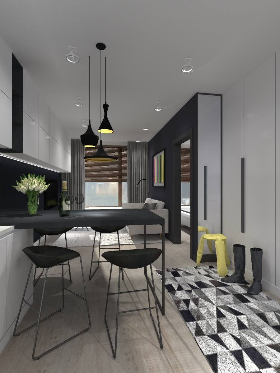 Wnętrze mieszkania w stylu nowoczesnym: czarne hokery przy czarnym blacie, geometryczny dywan, widok na salon z szarą sofą, trzy lampy wiszące o różnych kształtach nad blatem.