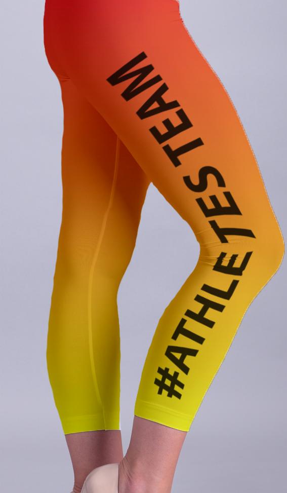 Nogawki legginsów z gradientem kolorów od czerwonego do żółtego, z nadrukowanym czarnym napisem #ATHLETES TEAM, na sylwetce osoby.